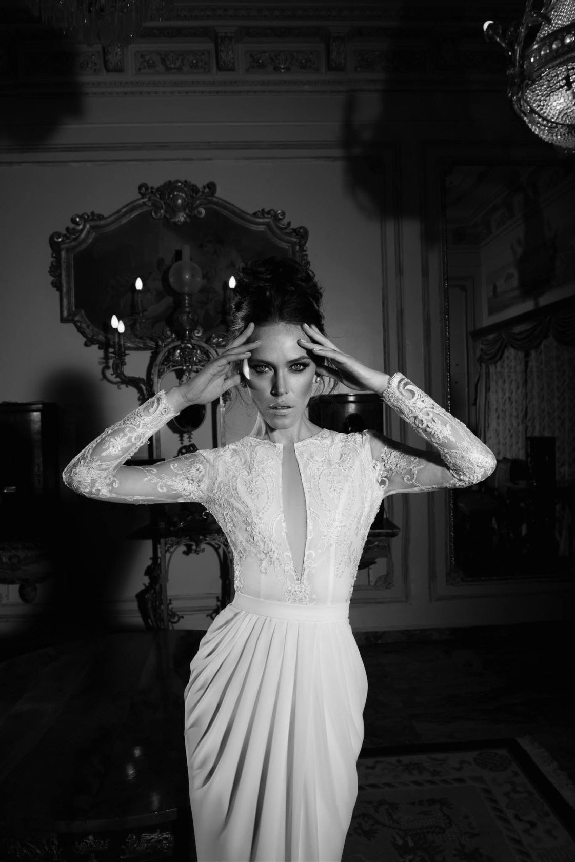 Hand-finished lace sleeve and draped hem