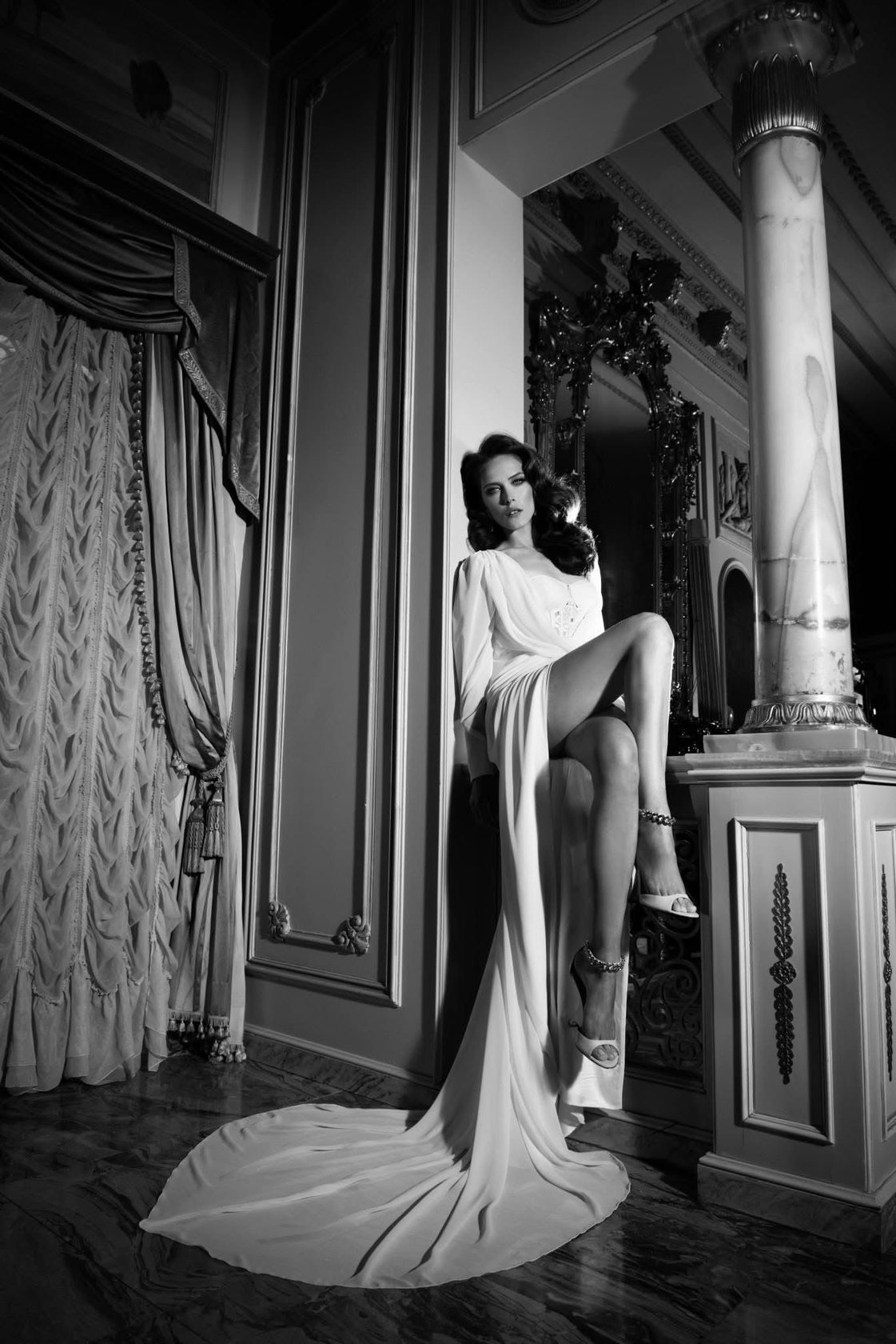 Bride in an ornate chateau room, slit gown