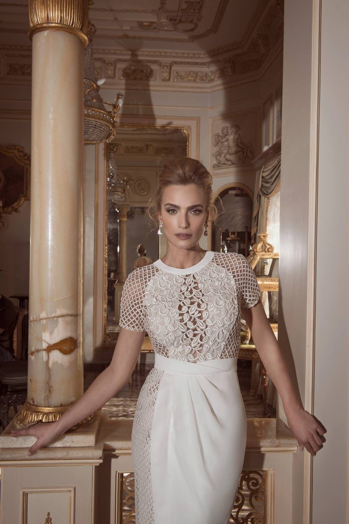 Bride in an onyx-columned palace room, lace gown