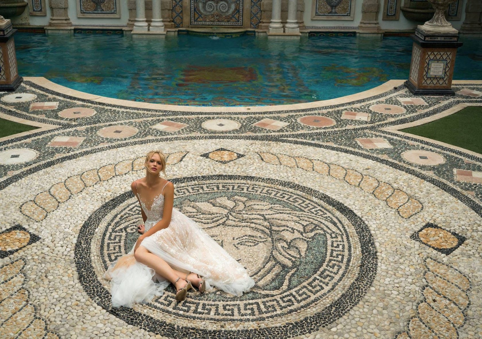 Bride seated on a mosaic terrace, tulle gown